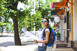 Happy student walking on the street